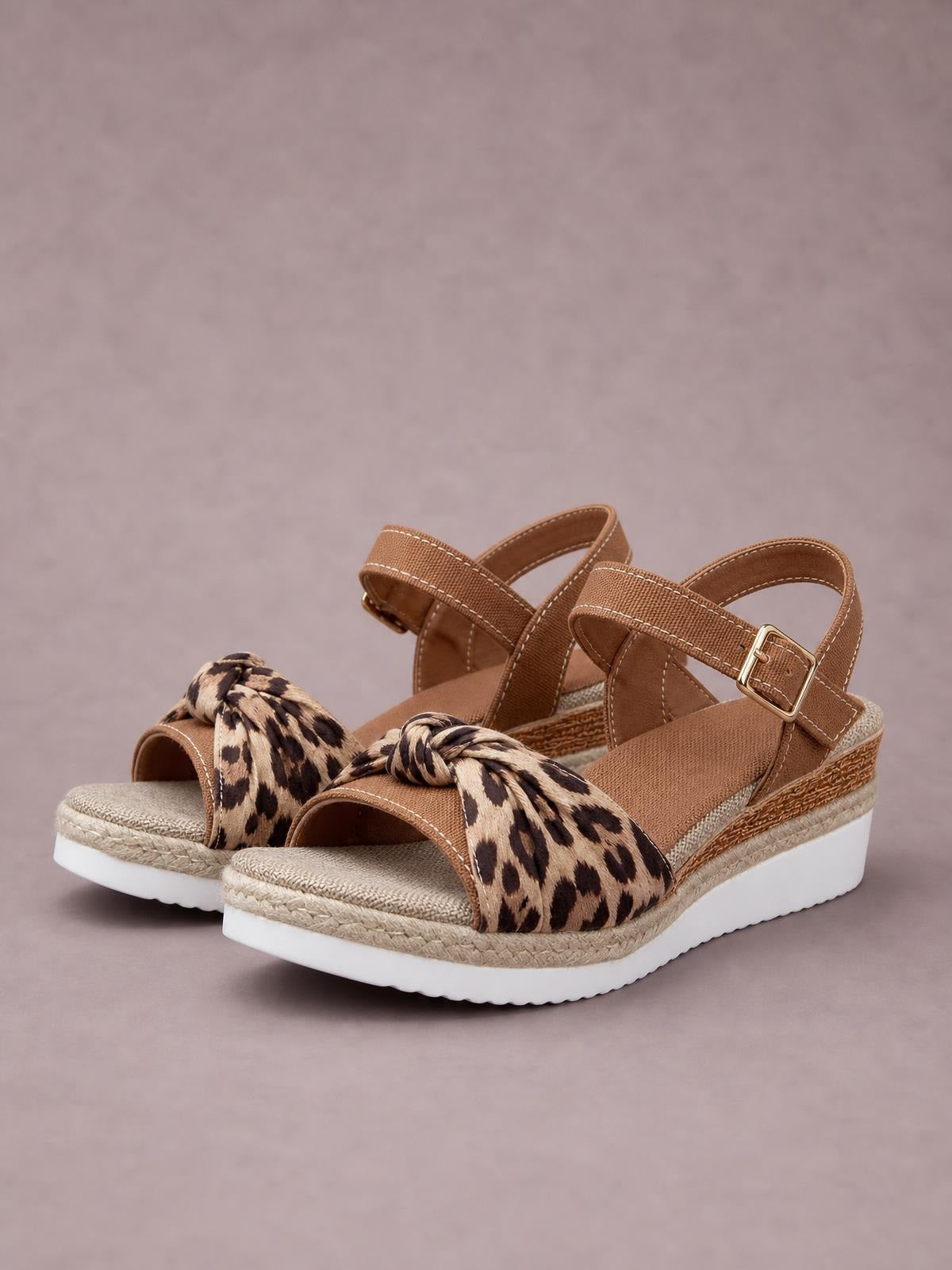 Tan open toe platform wedge sandals feature leopard-print braided straps, adjustable ankle buckles, textured midsoles, and comfortable mid-height wedges.