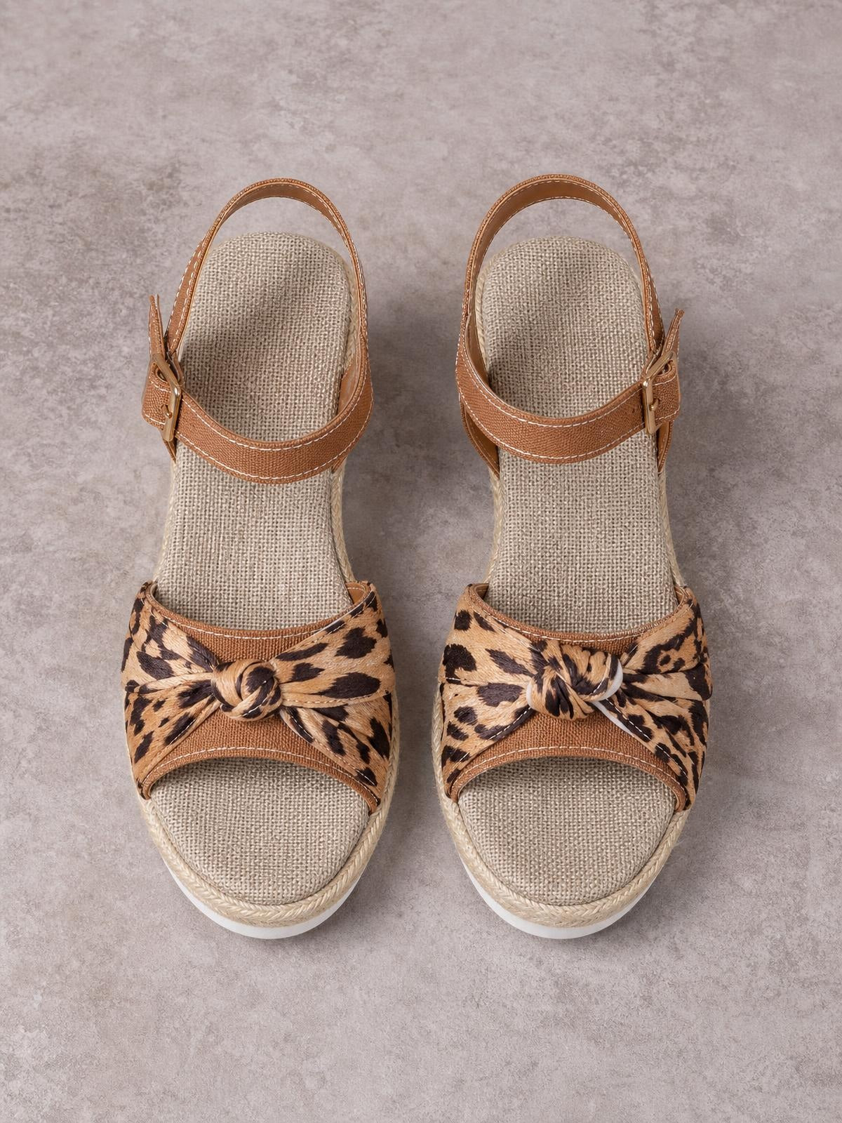 Tan open toe platform wedge sandals feature leopard-print knotted straps, ankle buckles, espadrille rope trim, and comfortable mid-height heels.