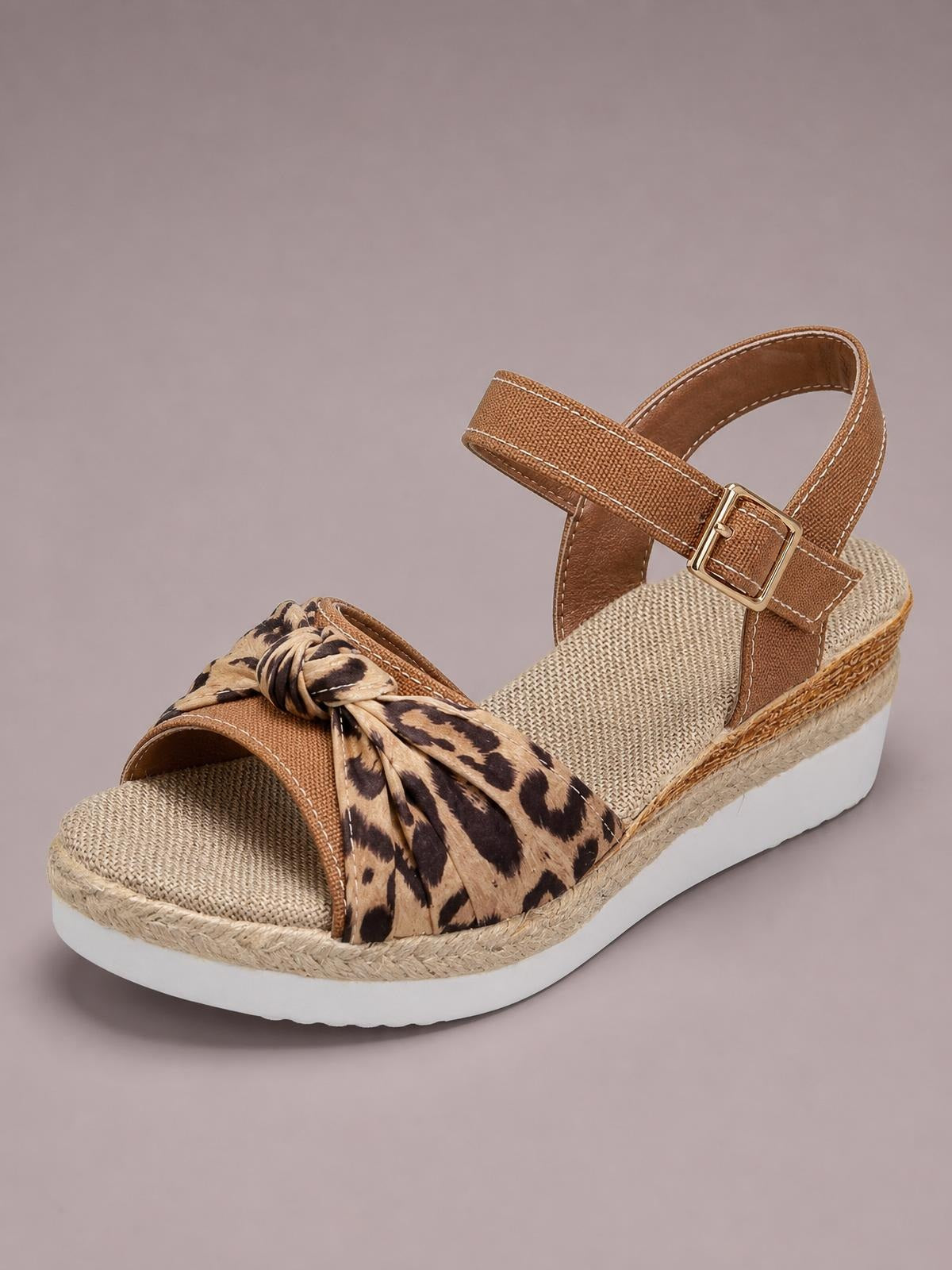 Brown open toe platform wedge sandal with a leopard-print bow, ankle buckle strap, espadrille-textured trim, and a comfortable mid-height white wedge sole.