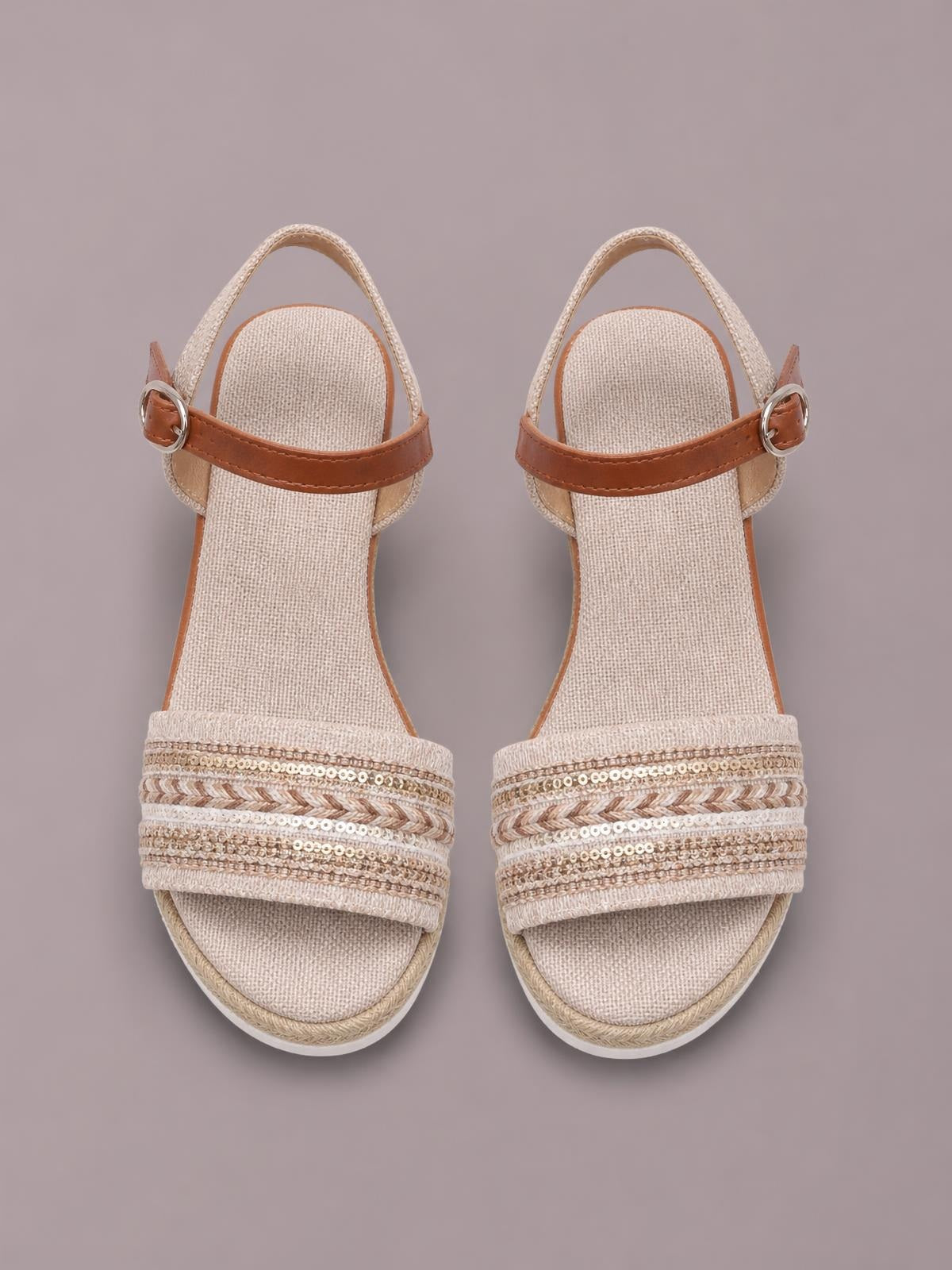 Neutral open toe platform wedge sandals with mid-height espadrille-style soles, ankle straps, buckles, and textured embellished crossover bands.