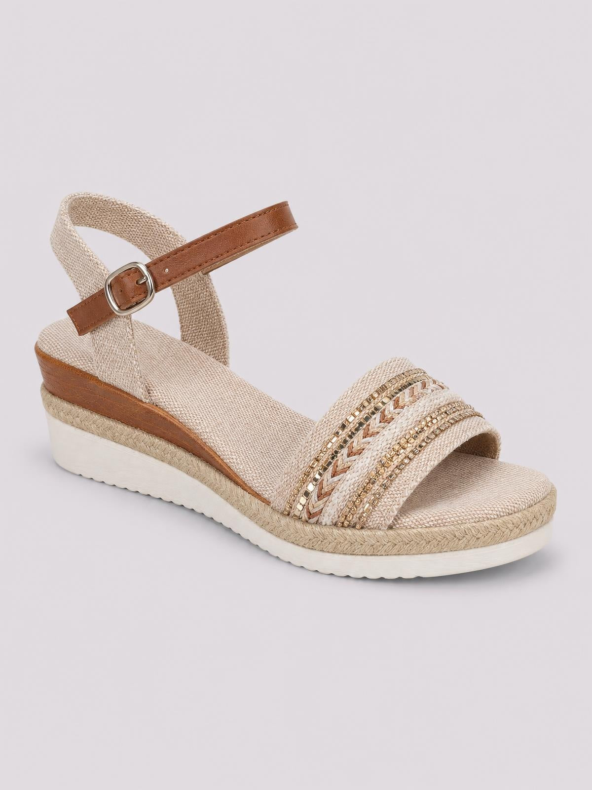 Beige open toe platform wedge sandal with a mid-height heel, ankle buckle strap, braided espadrille trim, and layered embellished front straps.