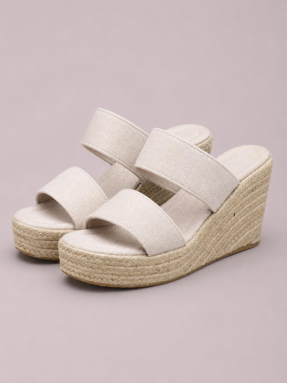 Cream open-toe platform wedge sandals feature two wide crossover straps and a textured woven espadrille-style mid heel with a chunky silhouette.