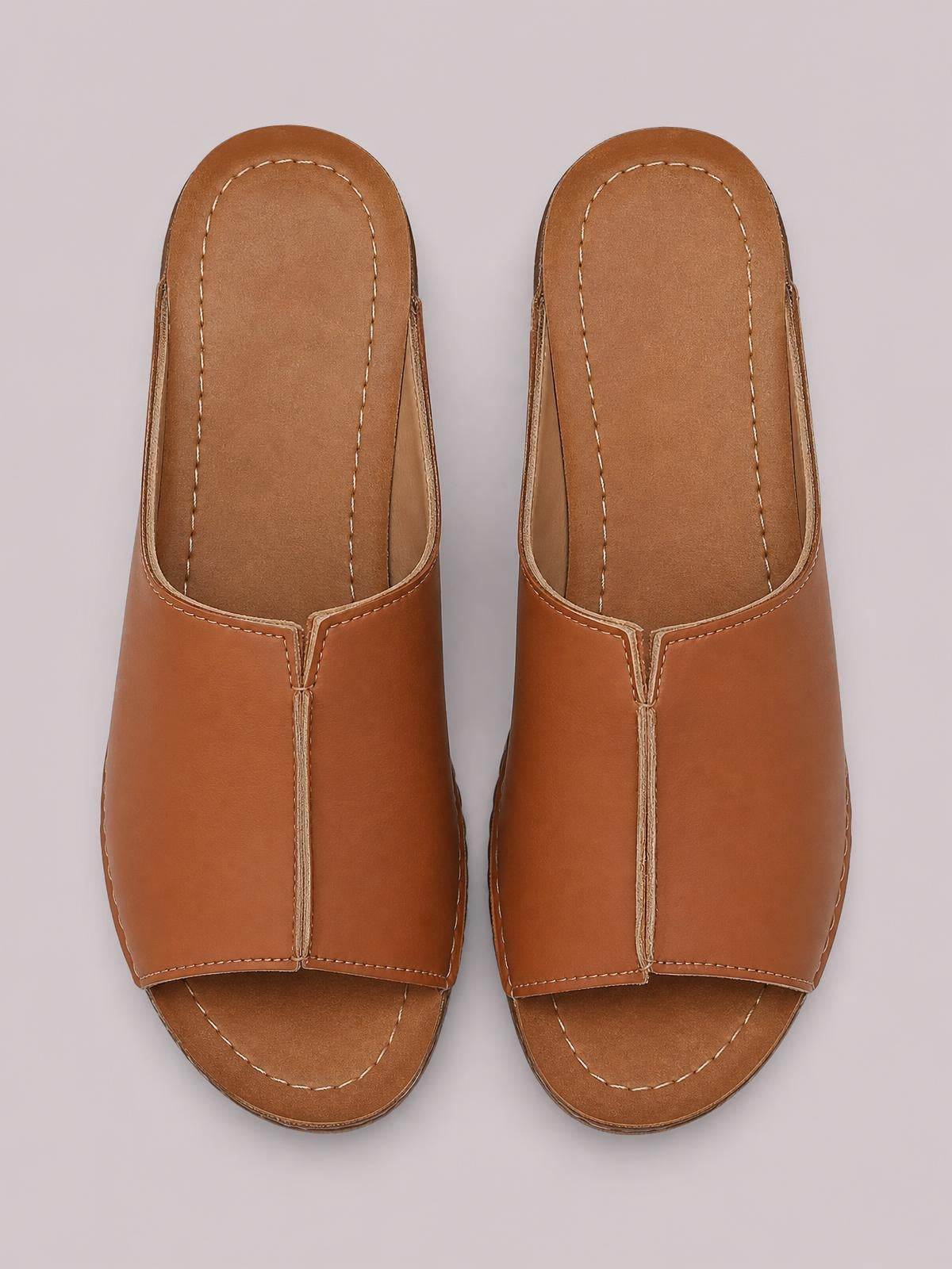 Brown open-toe wedge sandals with broad slip-on uppers, cushioned insoles, stitched edges, and low wedge heels in a sleek square-toe silhouette.
