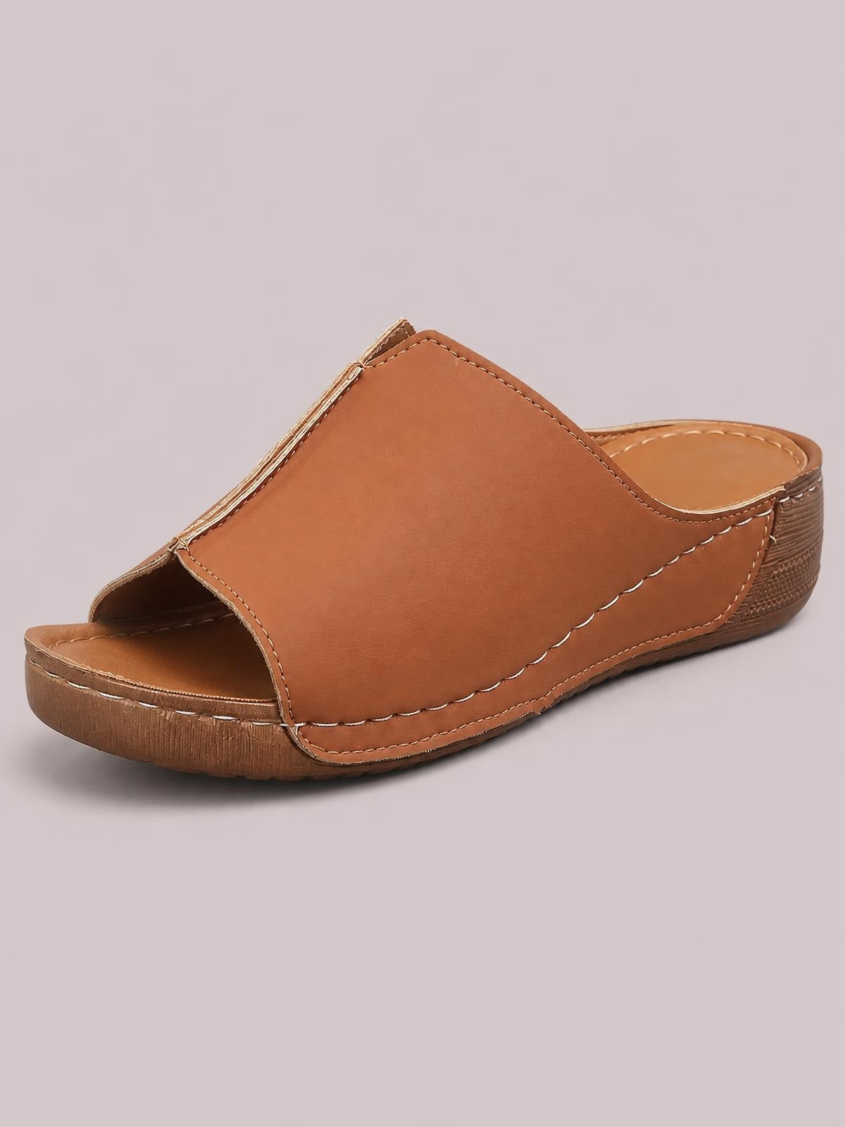 Brown open-toe wedge sandal with a wide smooth upper, stitched edges, open front, and low textured wedge sole.