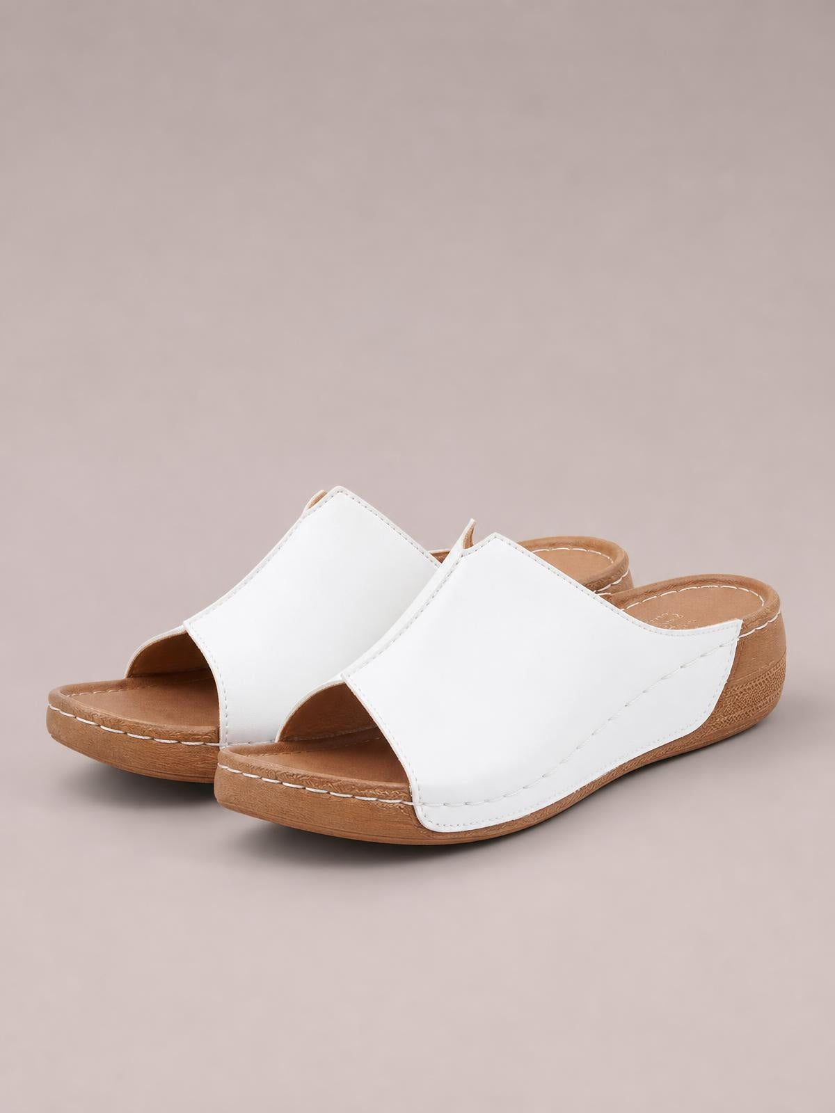 White open-toe wedge sandals with broad stitched PU straps, cushioned footbeds, and low wood-look wedge soles.
