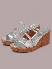 Silver open toe wedge sandals feature braided straps, quilted metallic toe bands, and textured brown mid-height wedge heels with a platform sole.