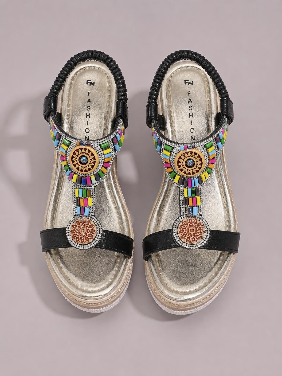 Black open toe wedge sandals with mid-height soles, colorful beaded embellishments, rhinestone trim, and decorative round medallions on the straps.