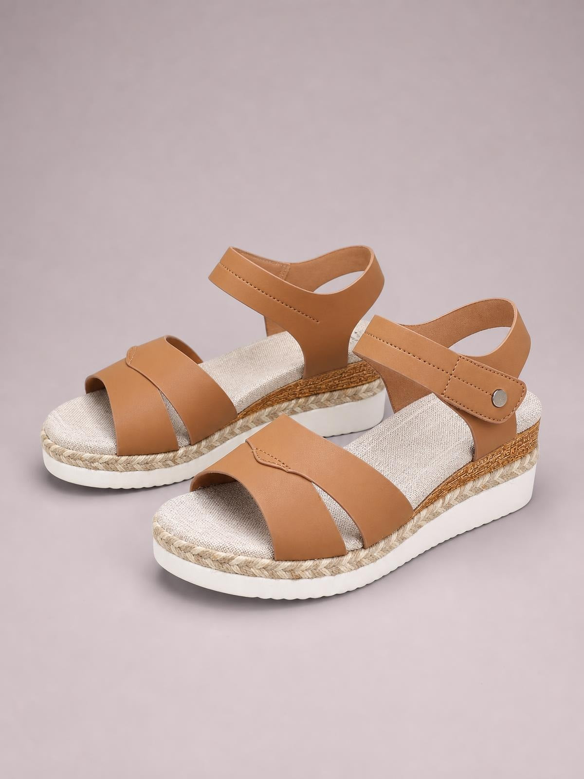 Tan PU leather open toe wedge sandals feature broad front straps, adjustable ankle closures, espadrille-style trim, and mid-height rubber platform soles.
