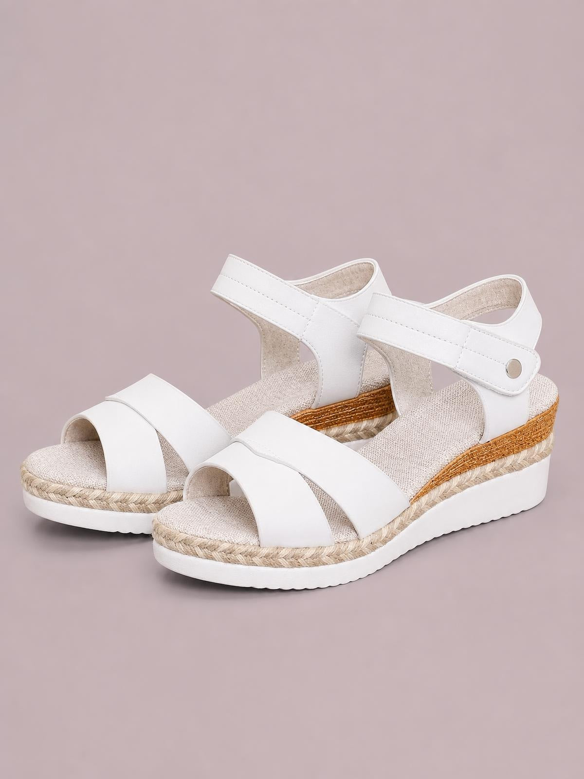 White open toe wedge sandals feature wide PU leather straps, adjustable ankle closures, braided trim, textured footbeds, and chunky rubber soles.