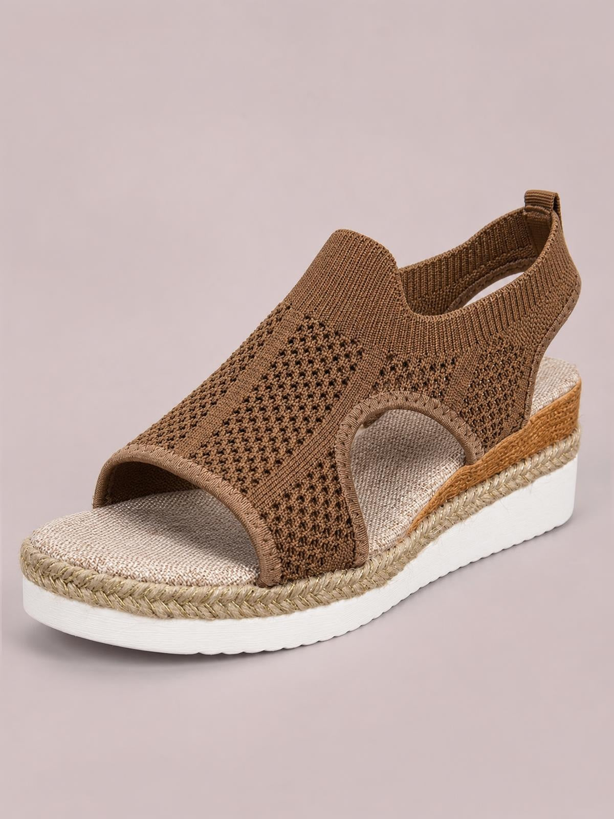 Brown open-toe woven wedge sandal with a textured upper, side cutout, ankle strap, braided trim, and a white mid-height rubber wedge sole.