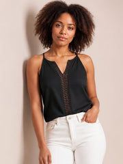 Model poses in a black openwork notched cami with thin straps, semi-sheer crochet-style center panel, relaxed straight silhouette, and lightweight construction.