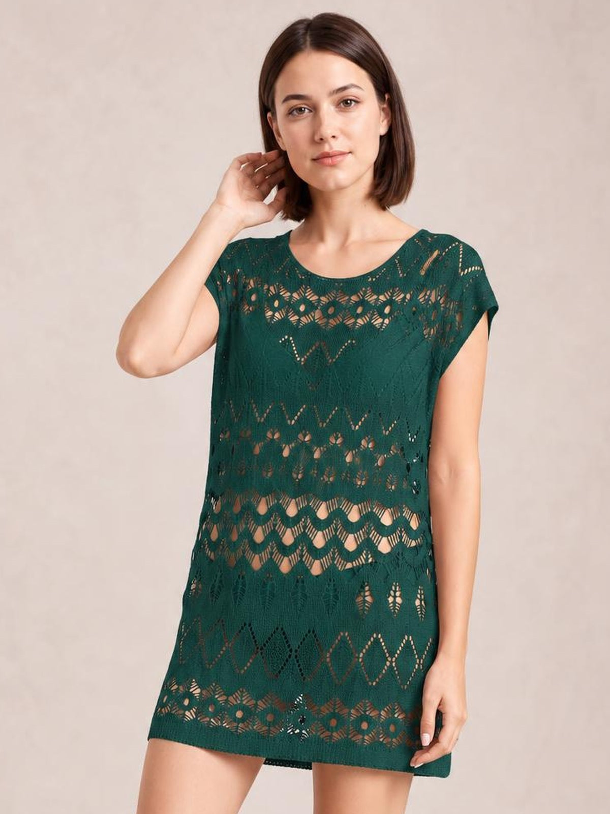 Model wearing a dark green openwork round neck cover-up with a relaxed straight silhouette, short sleeves, and patterned breathable cutout construction.