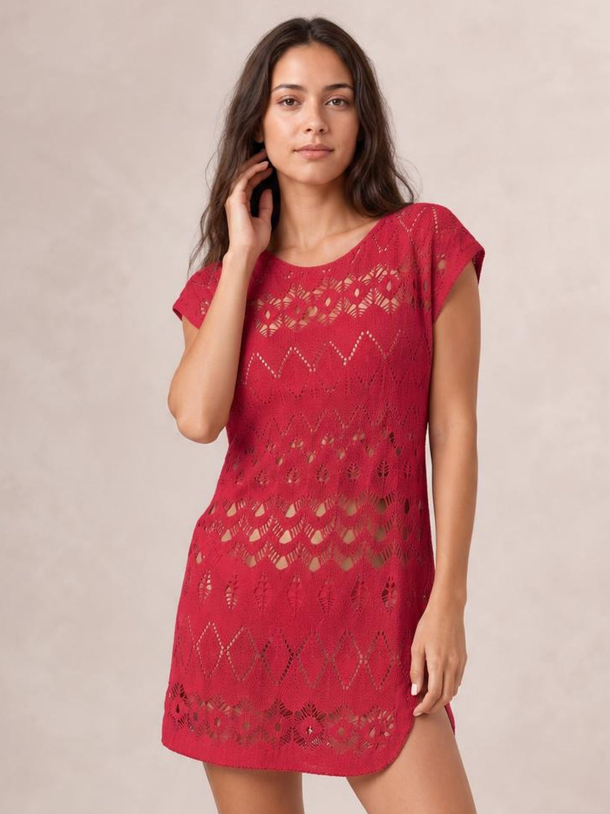 Model poses in a red openwork round neck cover-up with short sleeves, a relaxed straight silhouette, patterned cutout construction, and rounded hem.