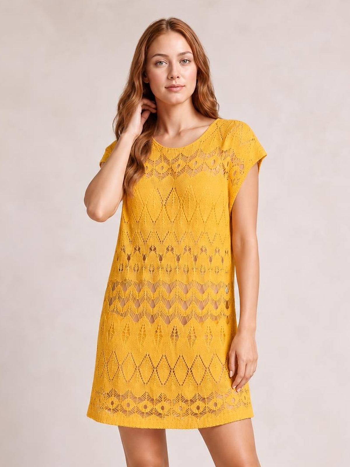 Model poses in a mustard yellow openwork round neck cover-up with short sleeves, a relaxed straight silhouette, and breathable patterned construction.