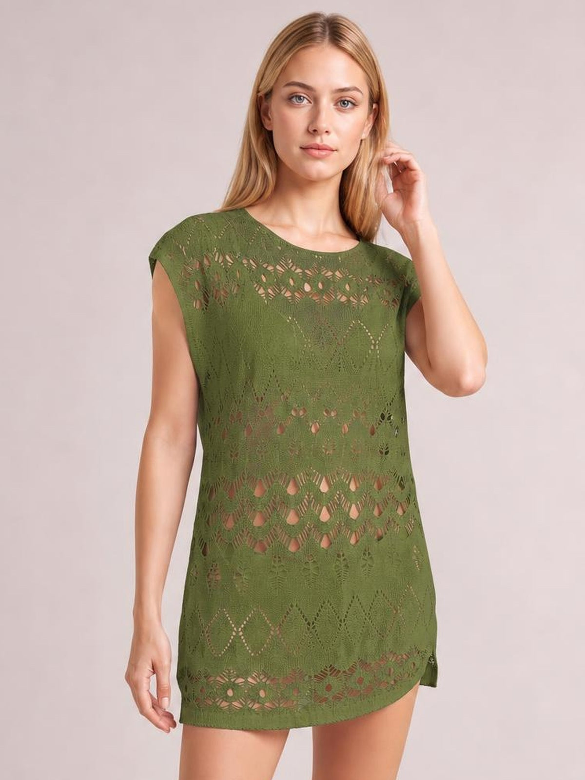 Model wearing a moss-green openwork round neck cover-up with short sleeves, a relaxed straight silhouette, and patterned cutout construction.