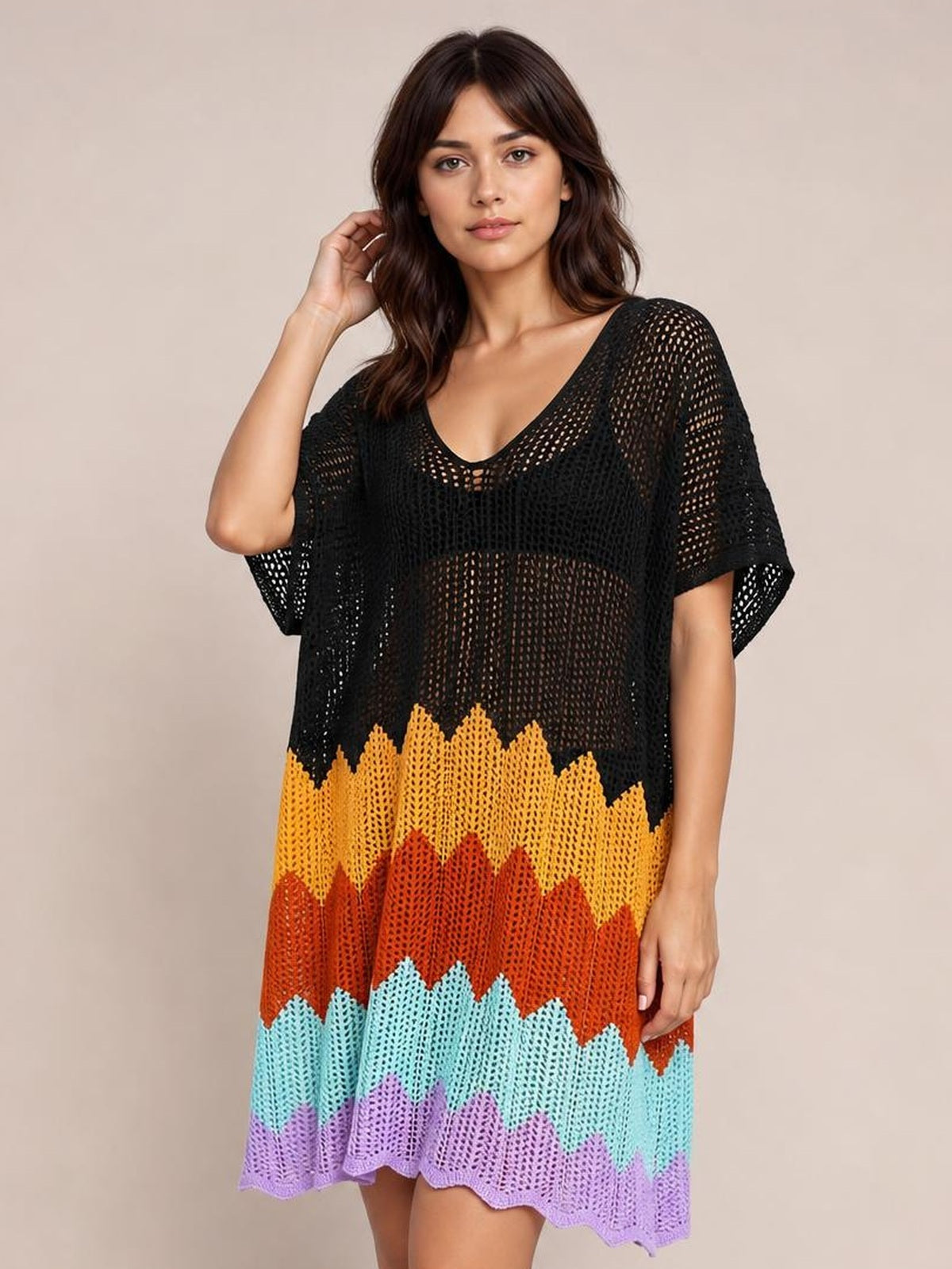 Model poses with one hand in her hair wearing a multicolor openwork V-neck half-sleeve cover-up with a loose silhouette and scalloped hem.