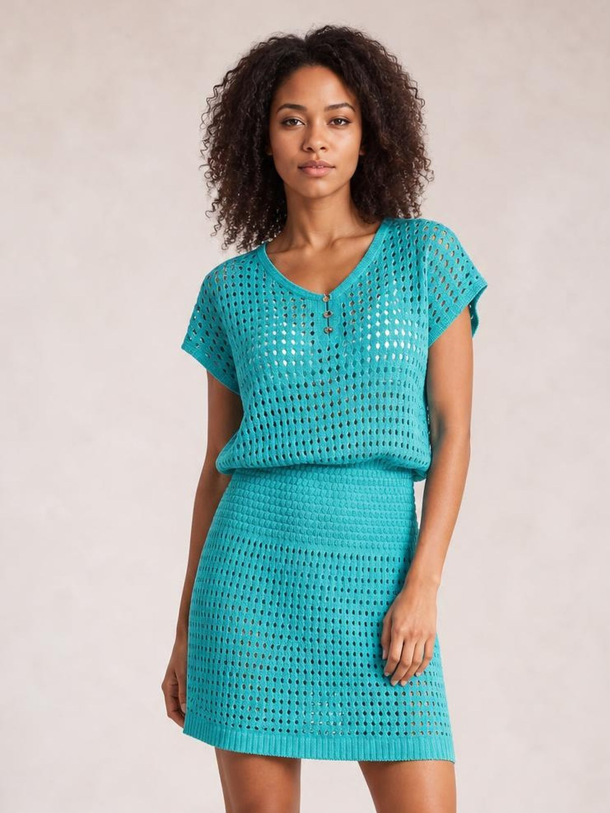 Model wearing a turquoise openwork V-neck short sleeve cover up with a semi-sheer knit, relaxed silhouette, button front, and ribbed hem.