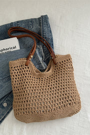 A medium tan openwork woven tote bag features a softly structured rectangular silhouette, breathable textured construction, and long brown shoulder straps.