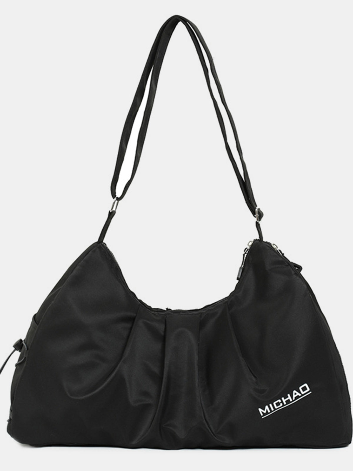 A large black Oxford cloth crossbody bag features a softly slouched silhouette, gathered front construction, and a long adjustable strap.