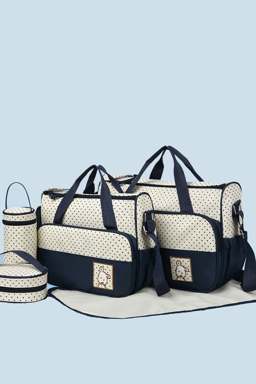 A coordinated Oxford cloth 4 piece bag set in cream with navy contrast trim includes a large tote, smaller tote, bottle bag, meal bag, and changing pad.
