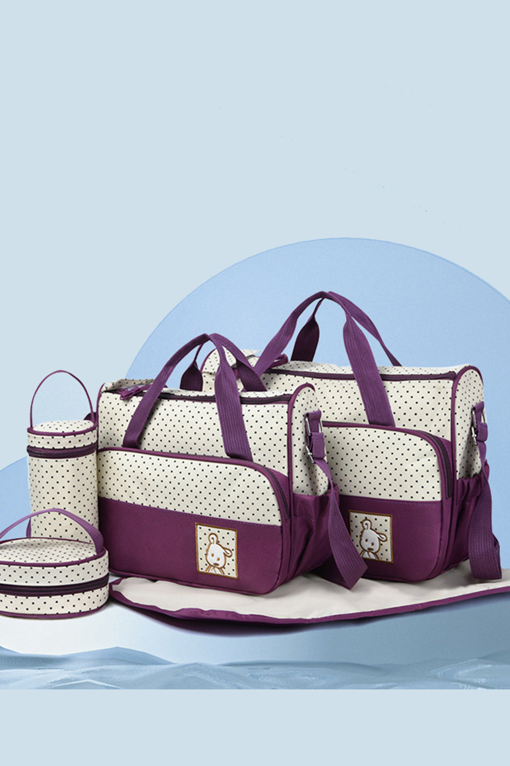 Oxford cloth contrast bag set in cream with plum trim, featuring large and small structured totes, a bottle bag, meal bag, and coordinating diaper pad.
