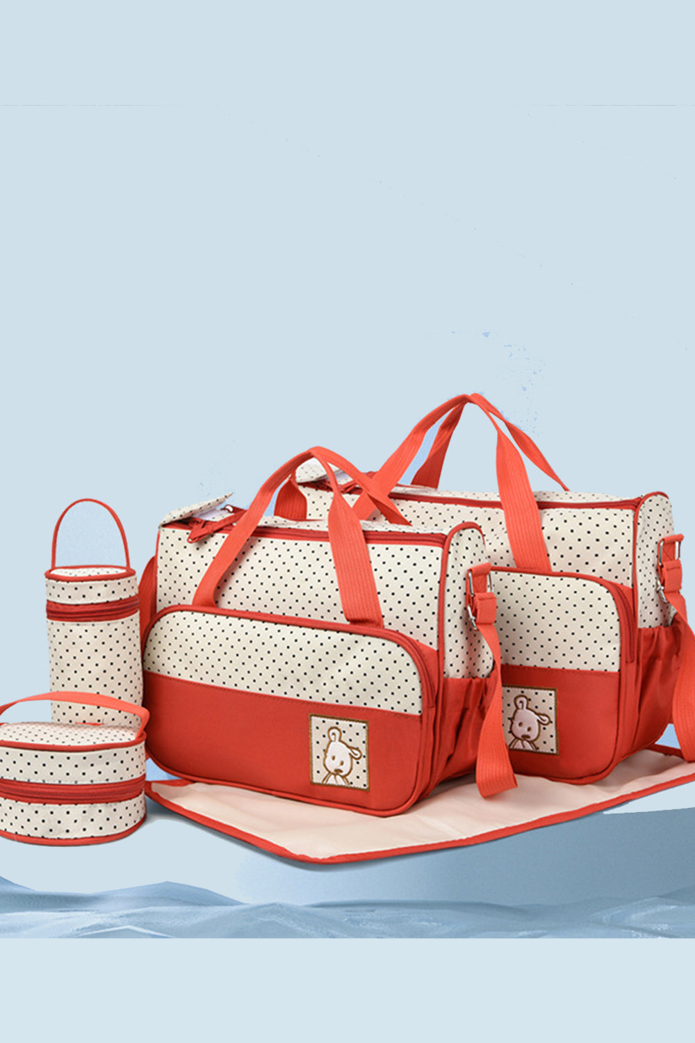A coordinated Oxford cloth contrast 4-piece bag set in cream with red trim and polka dots includes structured totes, bottle and meal bags, and a diaper pad.