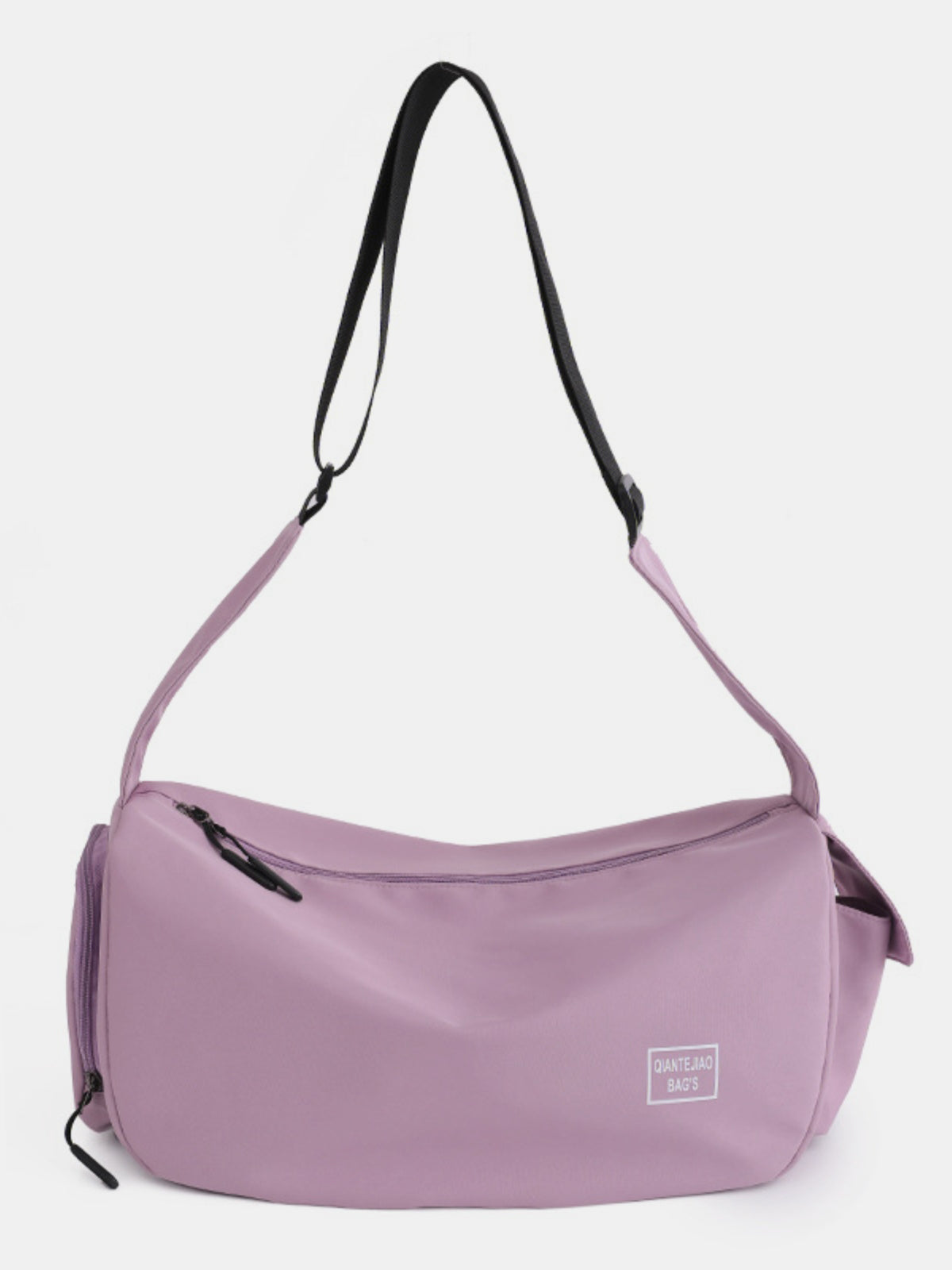 Large lavender Oxford cloth crossbody bag with a softly curved, slouchy silhouette, long adjustable strap, zip-top closure, and external zip compartments.