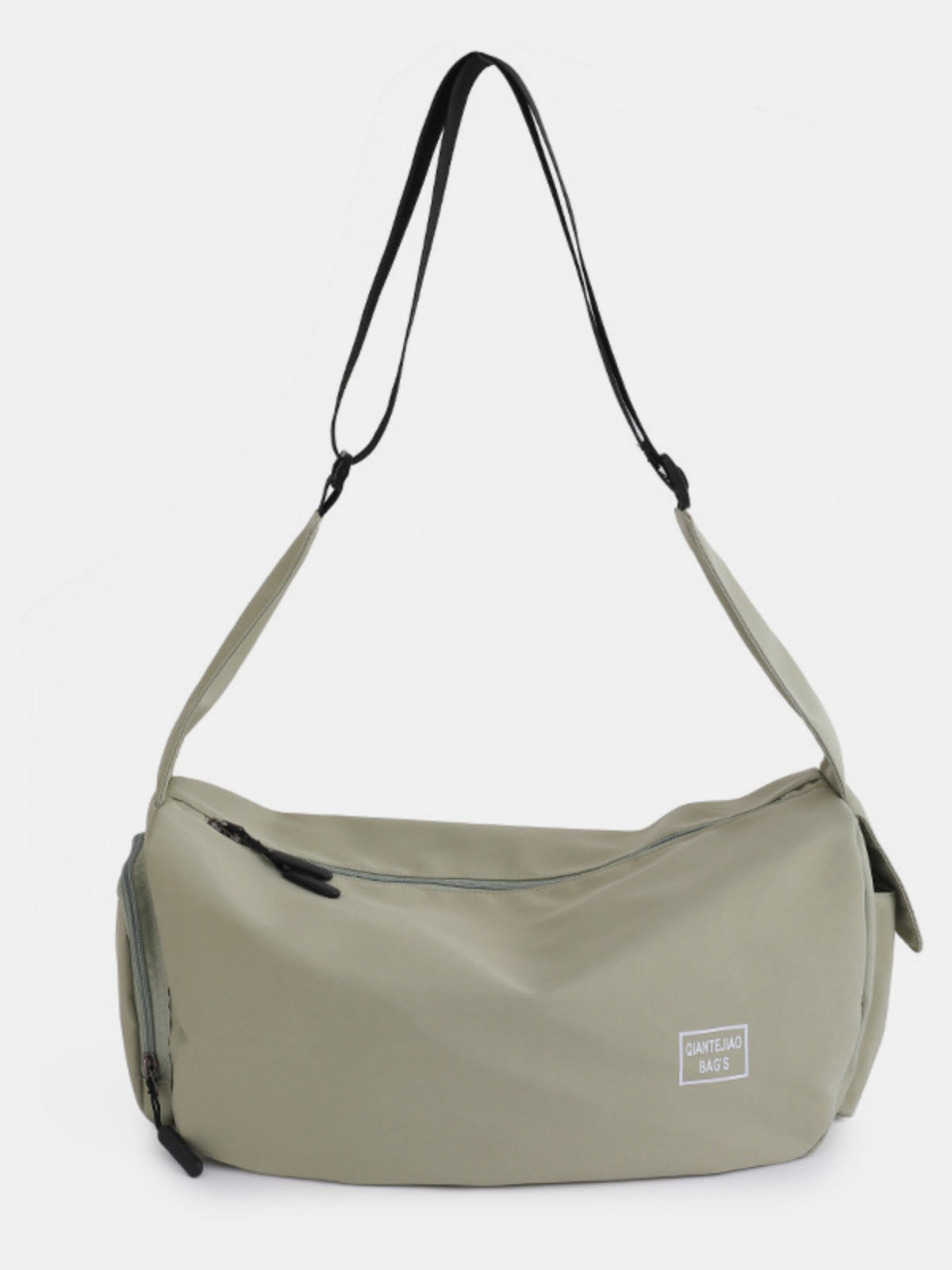 Large sage-green Oxford cloth crossbody bag with a softly curved, slouchy silhouette, long adjustable strap, zip-top opening, and external zip compartments.