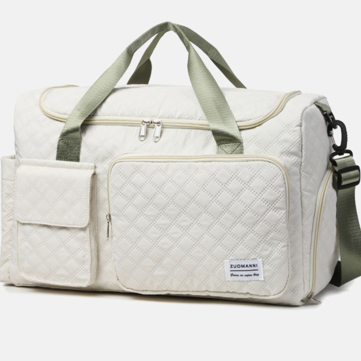 An oversize cream Oxford cloth travel bag with a quilted duffel silhouette, multiple front pockets, sturdy top handles, a zip-top closure, and a shoulder strap.