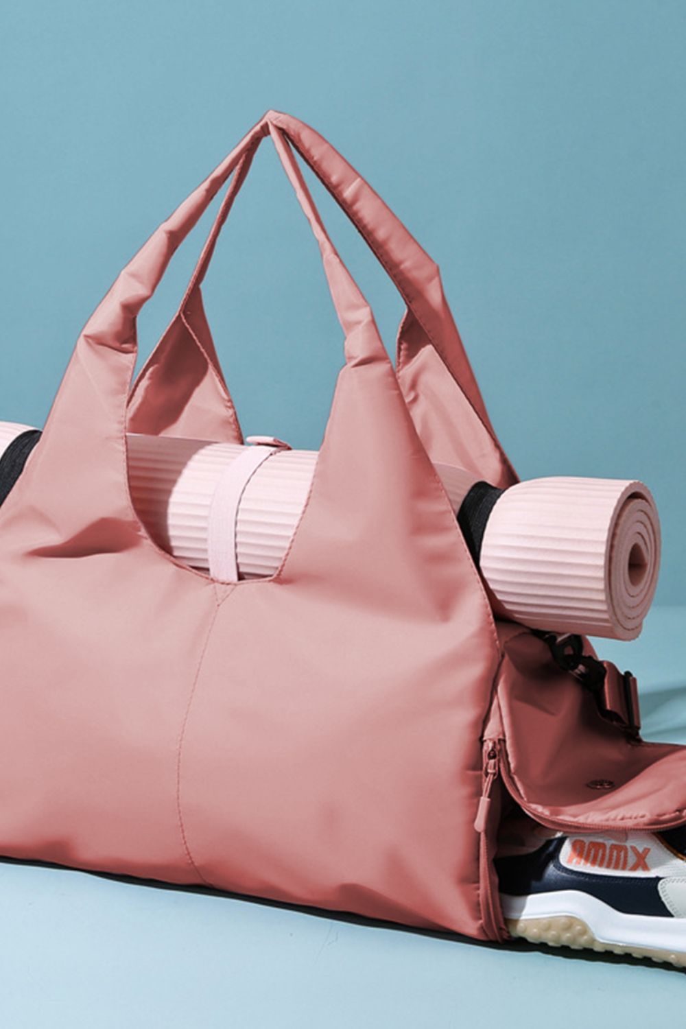 Large pink Oxford cloth waterproof travel bag with a broad, softly structured silhouette, generous top handles, and roomy construction for versatile everyday carrying.