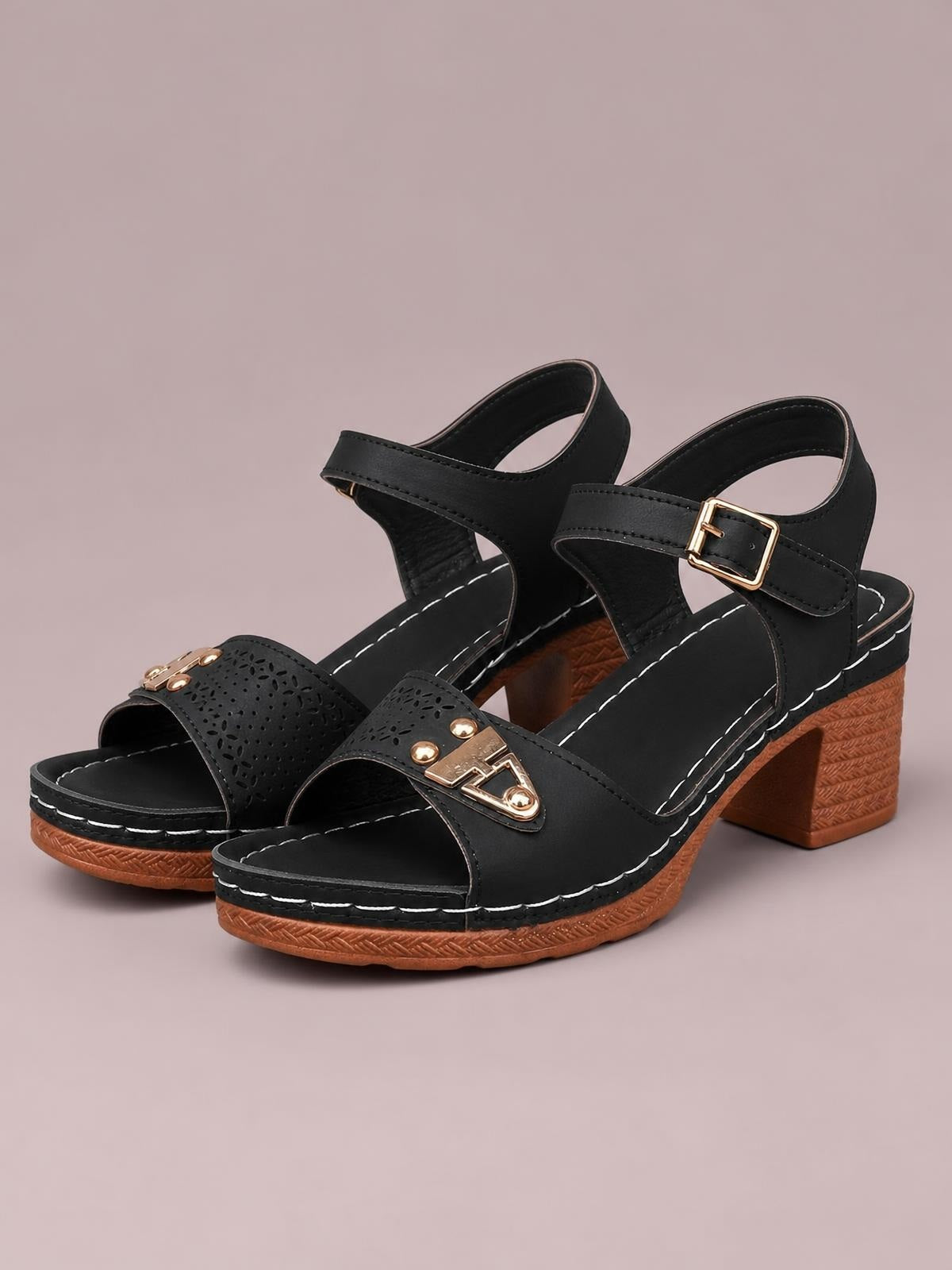 Black peep toe block heel sandals feature perforated vamp straps, gold-tone buckle accents, ankle straps, and textured mid-height block heels.