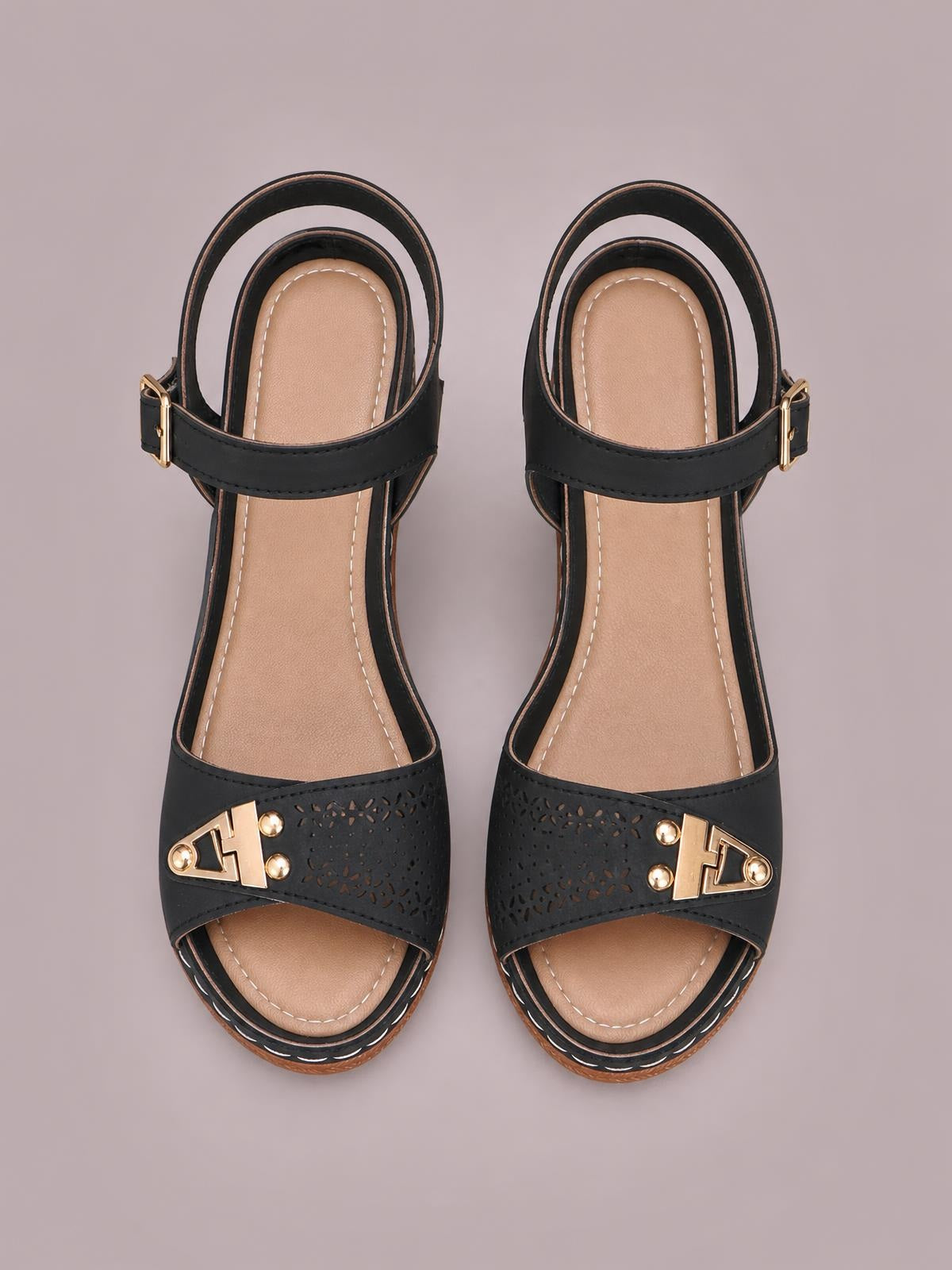 A top-down view shows black peep toe block heel sandals with perforated straps, gold-tone hardware, ankle buckles, and tan cushioned footbeds.