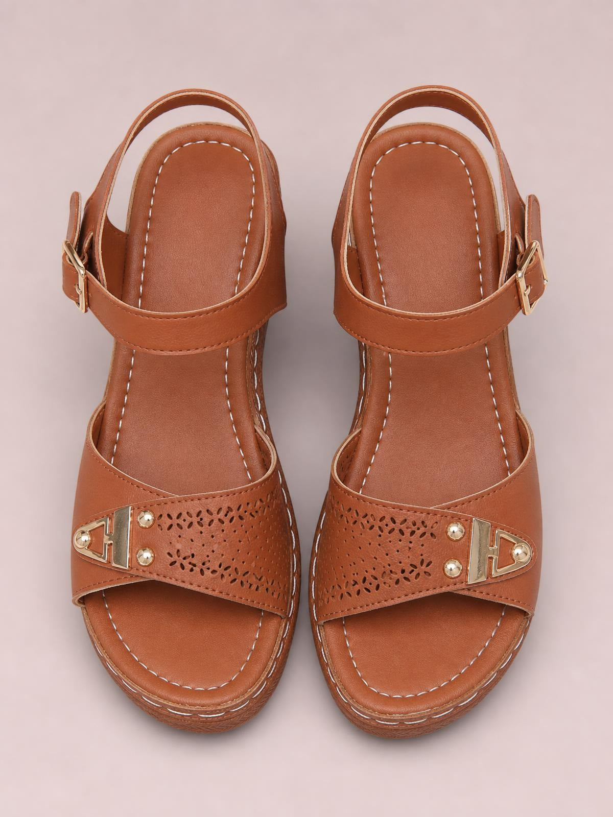Brown peep-toe block heel sandals feature wide perforated straps, gold-tone buckle accents, ankle straps, and stitched cushioned footbeds.