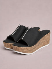 Black peep toe high heel sandals feature wide PU uppers with silver trim, cushioned footbeds, cork-textured wedge platforms, and white rubber soles.