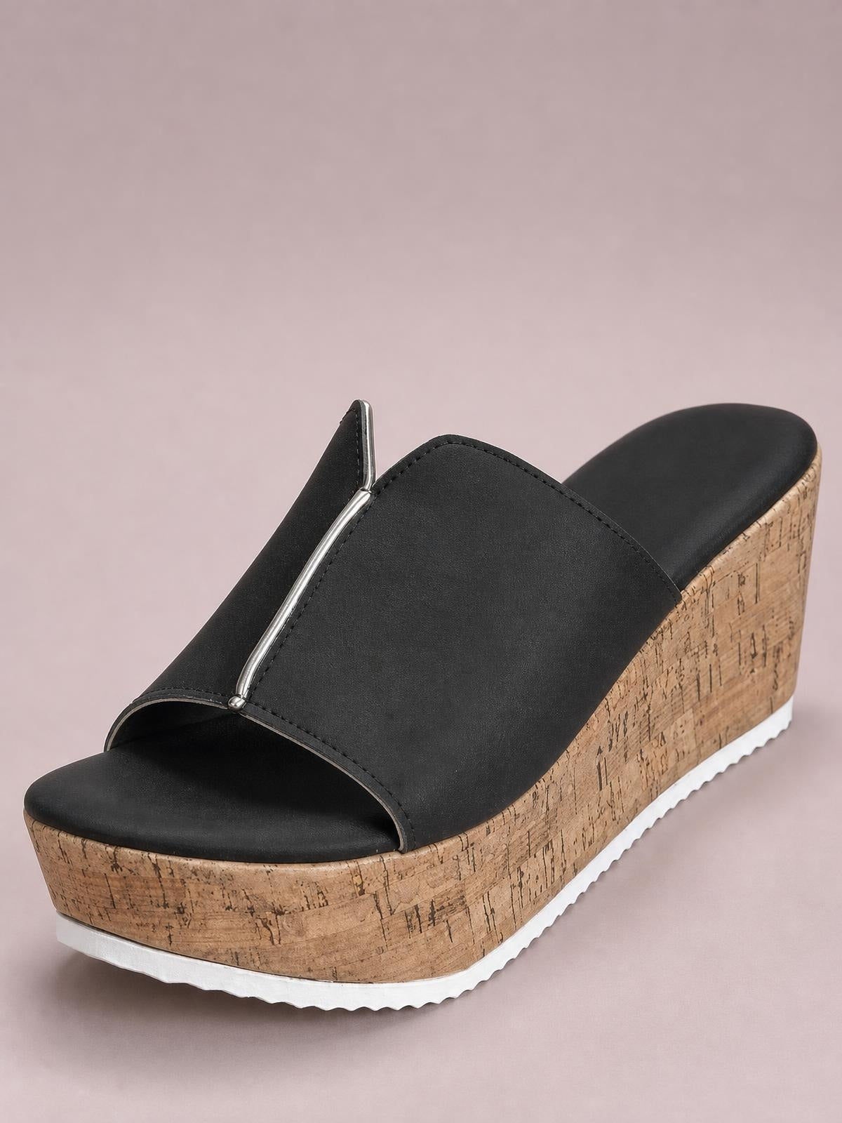 Black peep-toe high heel sandal with a wide smooth upper, metallic center accent, tall cork wedge platform, and white textured outsole.
