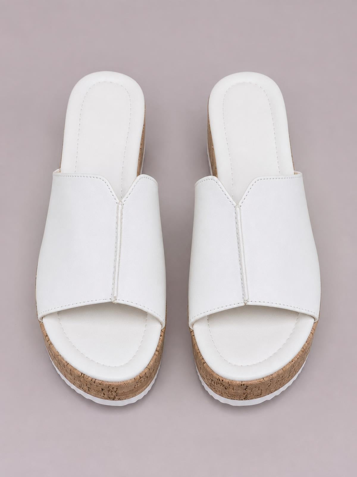 White peep toe high heel sandals with wide stitched upper straps and cork-textured wedge soles, shown as a matching pair from above.