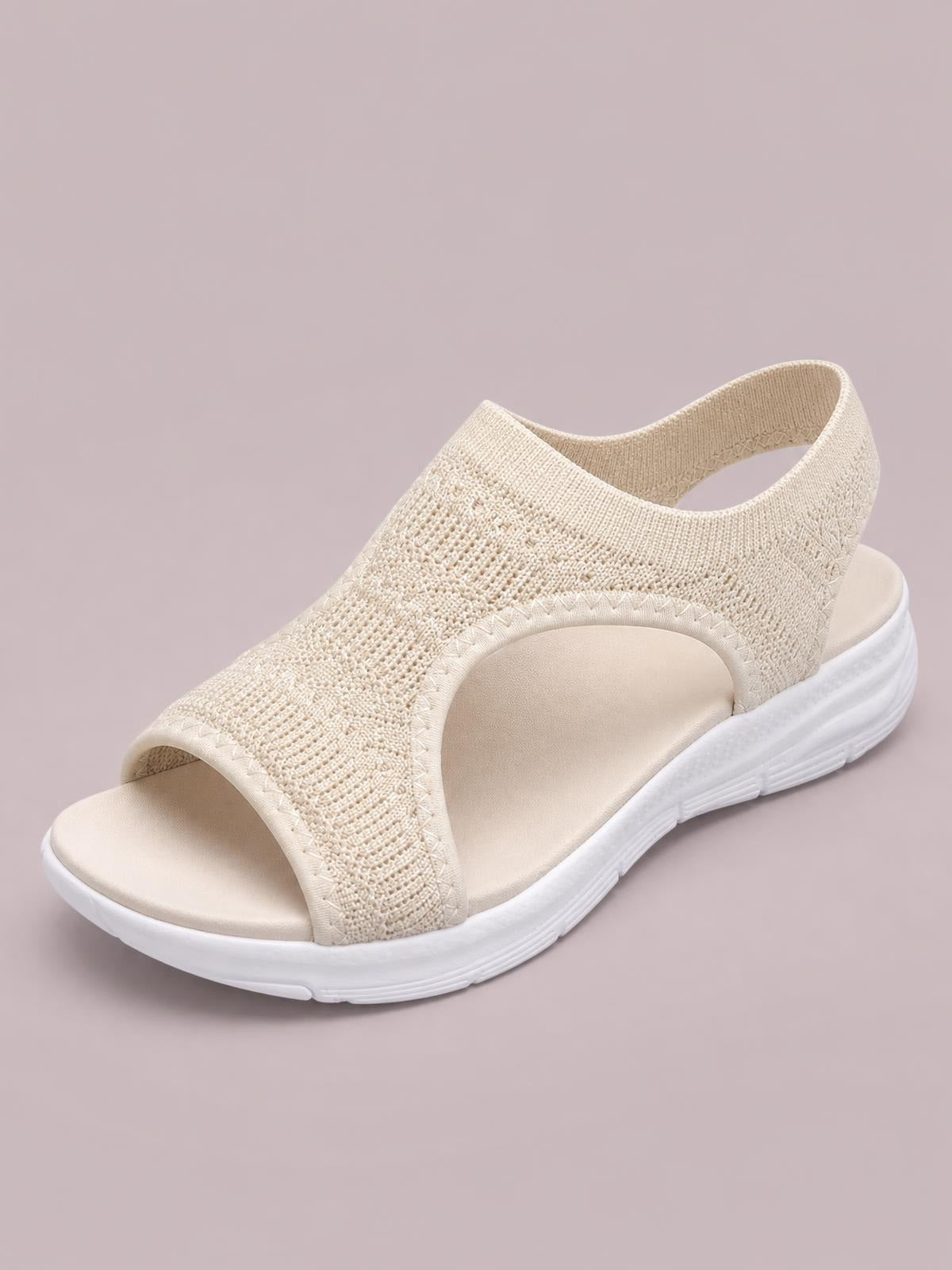 Cream solid-color peep-toe sandals with a woven cloth upper, wide open-side straps, cushioned footbed, and a flat white rubber sole.
