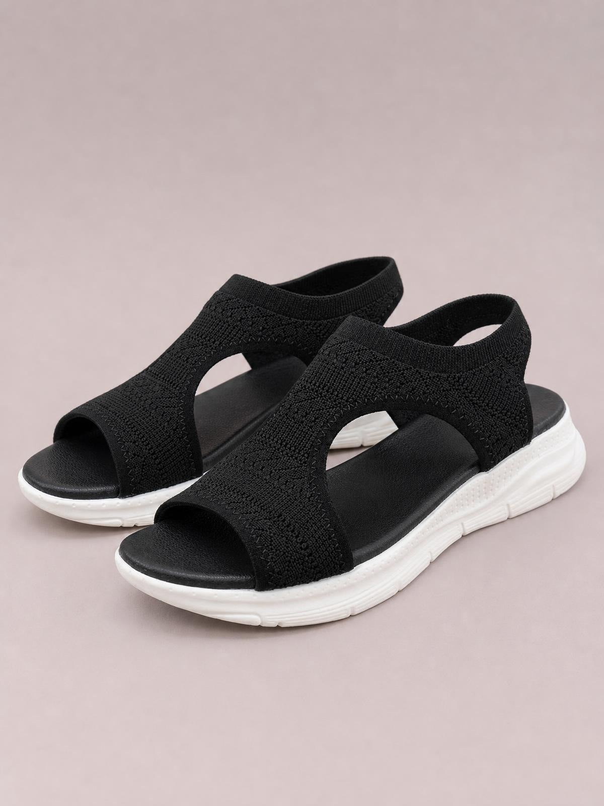 Black solid-color peep-toe sandals feature textured cloth uppers, open sides, cushioned footbeds, and thick white flat rubber soles.