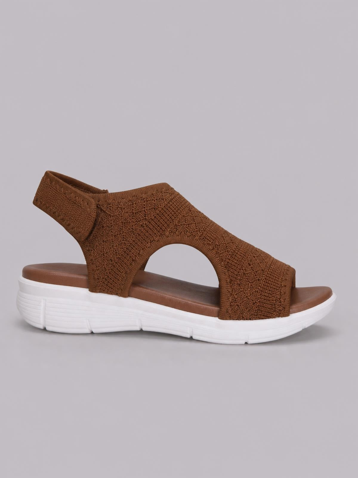 Brown solid-color peep-toe sandals feature a textured cloth upper with a curved side cutout and a white rubber sole with a flat platform profile.