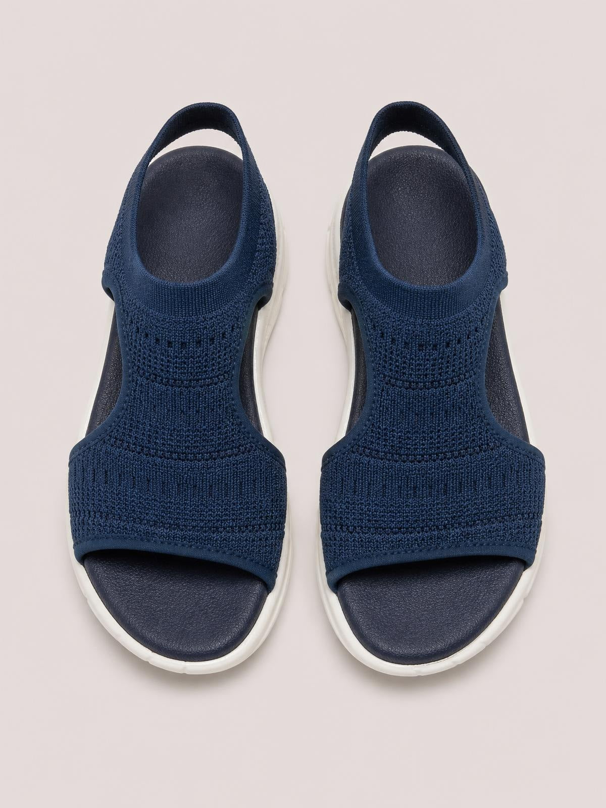 Navy solid-color peep-toe flat sandals feature textured cloth uppers, broad straps, open toes, heel straps, and contrasting white rubber soles.