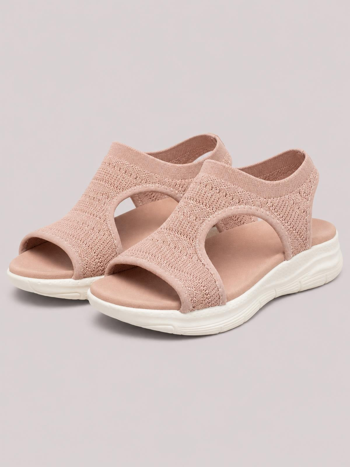 Blush solid-color peep-toe sandals feature textured cloth uppers, open side panels, cushioned footbeds, and lightweight flat rubber soles.