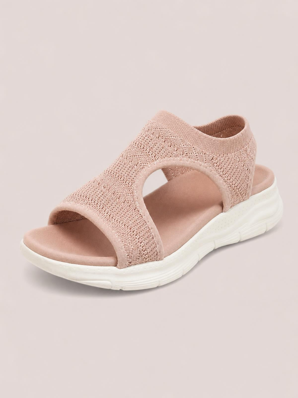 Dusty pink peep-toe sandals feature a woven cloth upper, wide cross straps, open sides, and a cushioned flat white rubber sole.