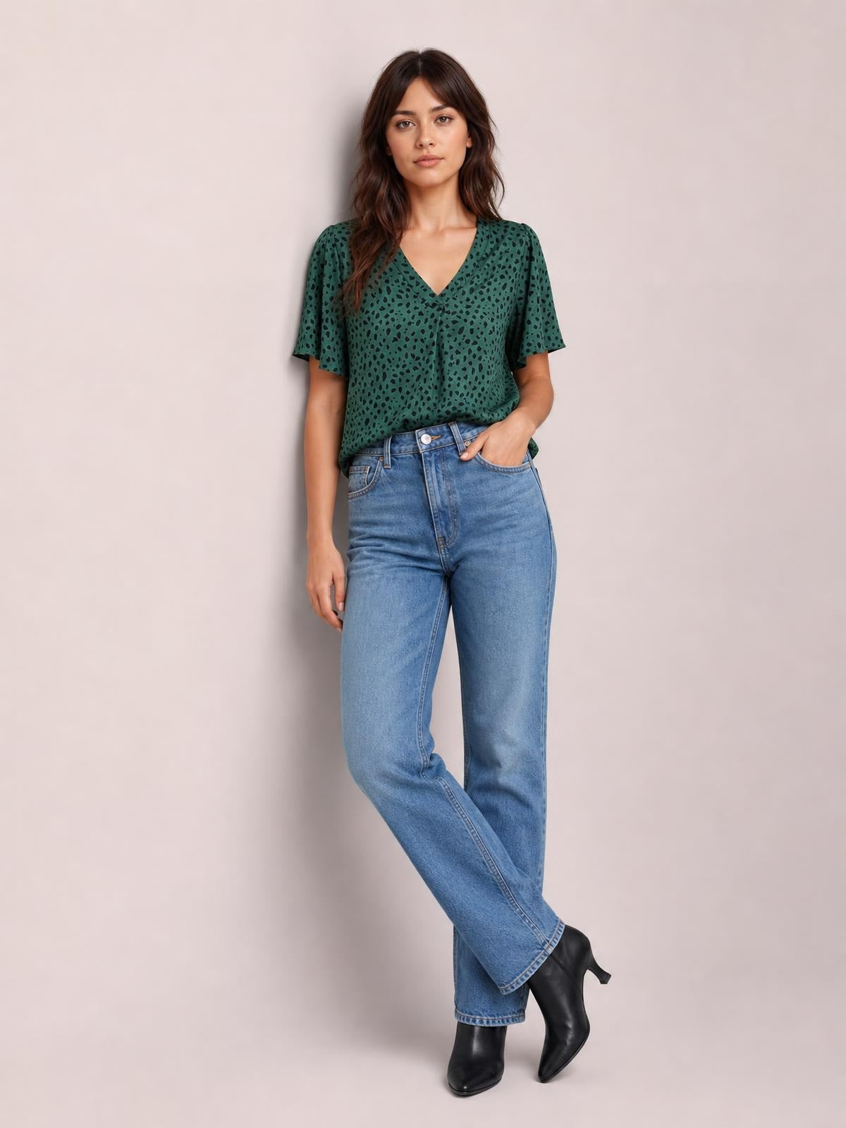 Model poses in a green leopard-print blouse with a V-neck, short flutter sleeves, and a relaxed regular-length silhouette.