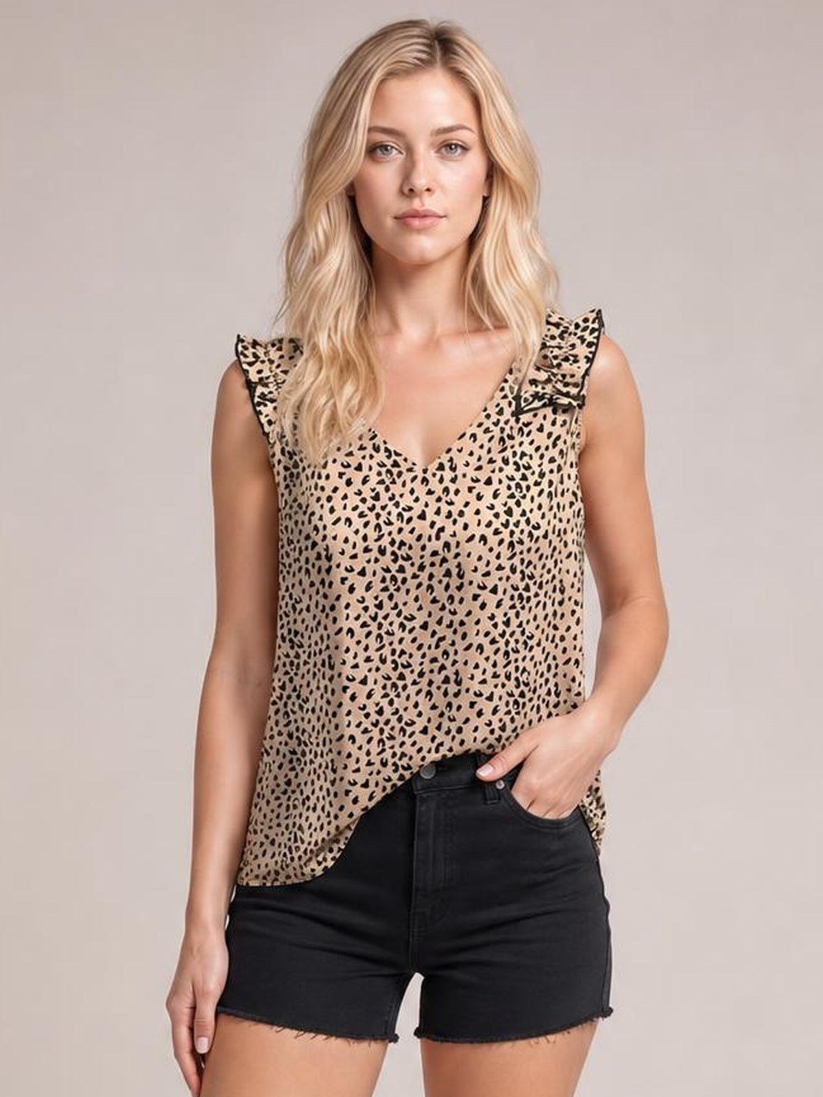 Model wears a tan leopard-print sleeveless tank with a V-neck, ruffled shoulder trim, and a relaxed regular-length silhouette.