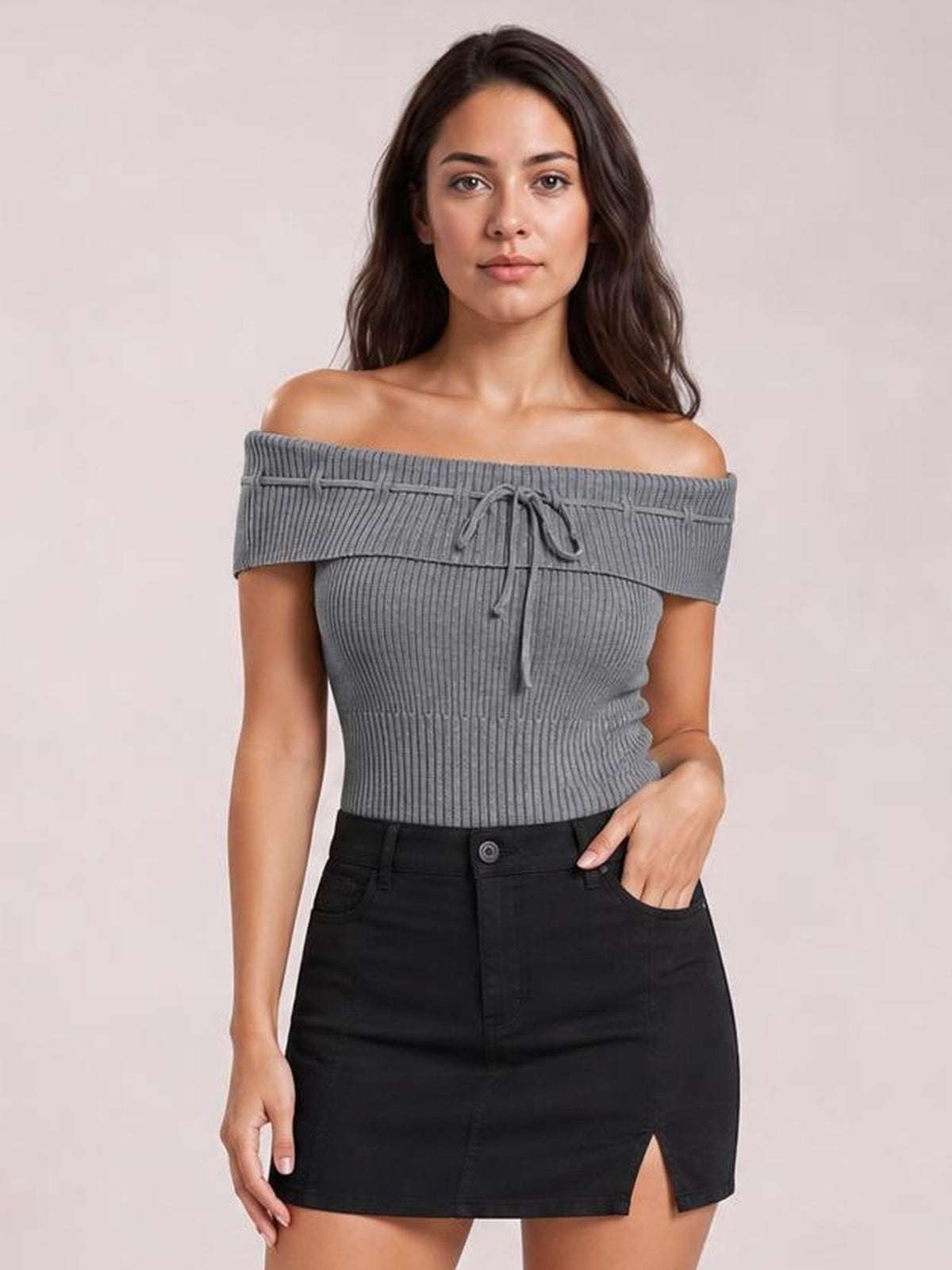 A model wears a gray ribbed knit top with an off-shoulder neckline, short sleeves, tied front detail, and a fitted silhouette.