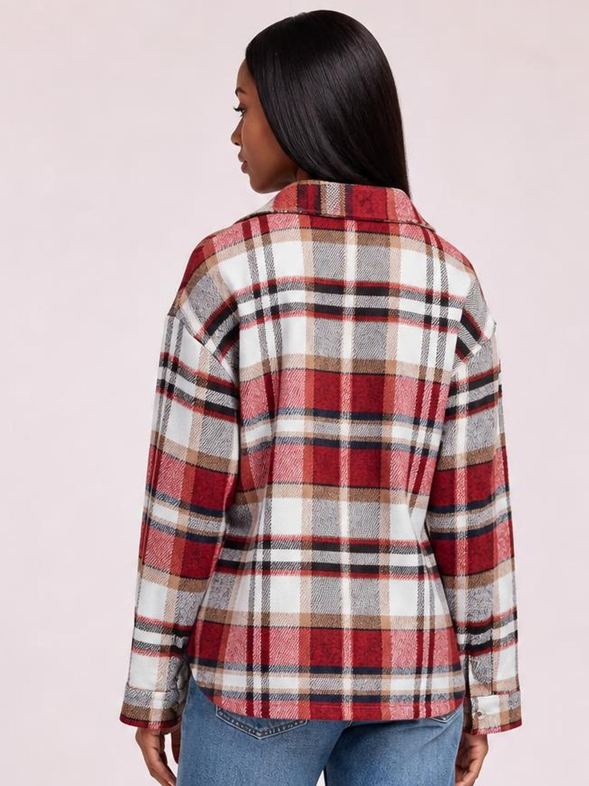 Model shown from behind wearing a red, white, and beige plaid button-front shirt jacket with a collar, long dropped-shoulder sleeves, and an easy fit.