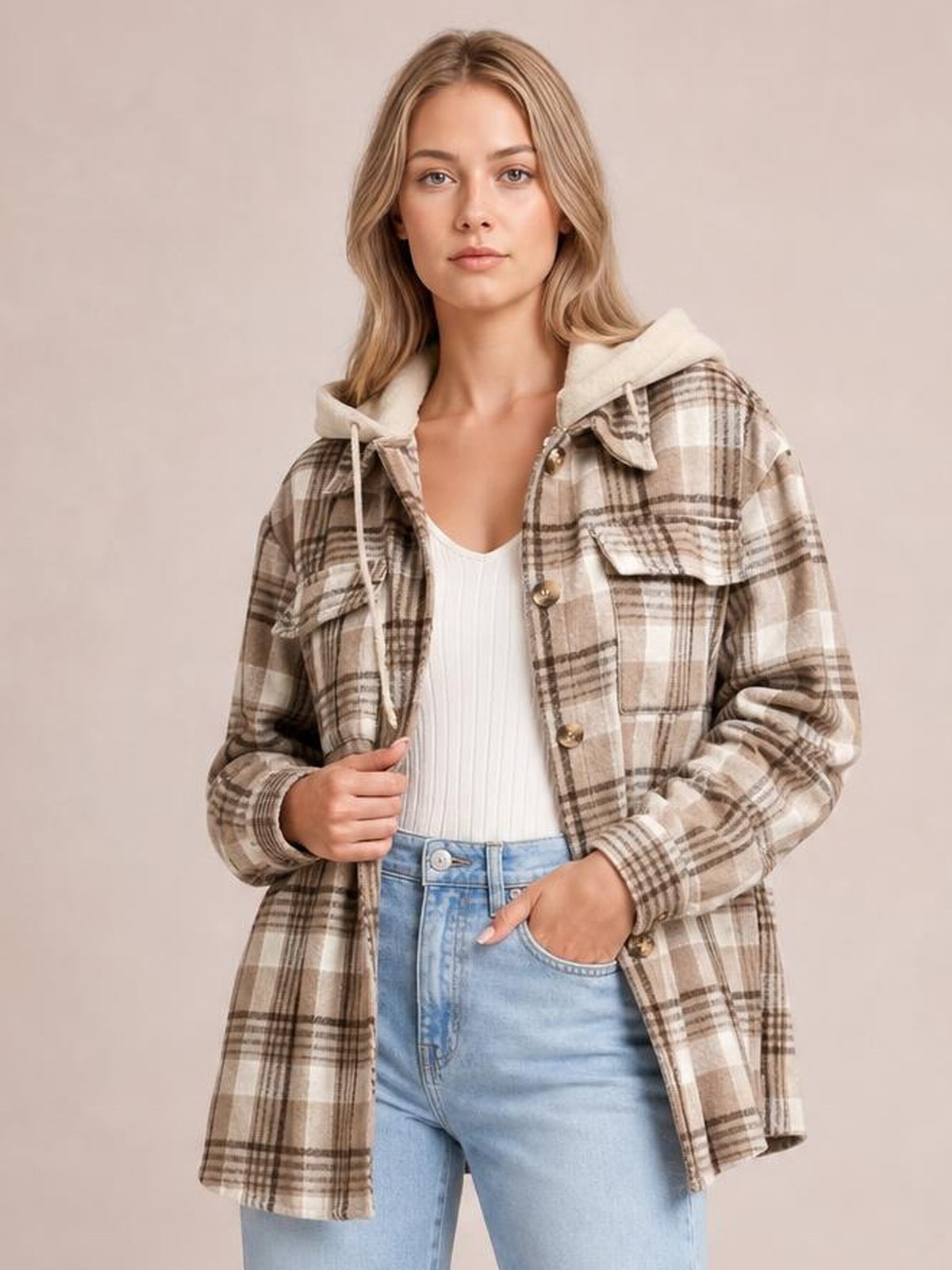 Model wears a relaxed beige plaid button-up jacket with a removable hood, chest pockets, long sleeves, and a straight mid-thigh silhouette.