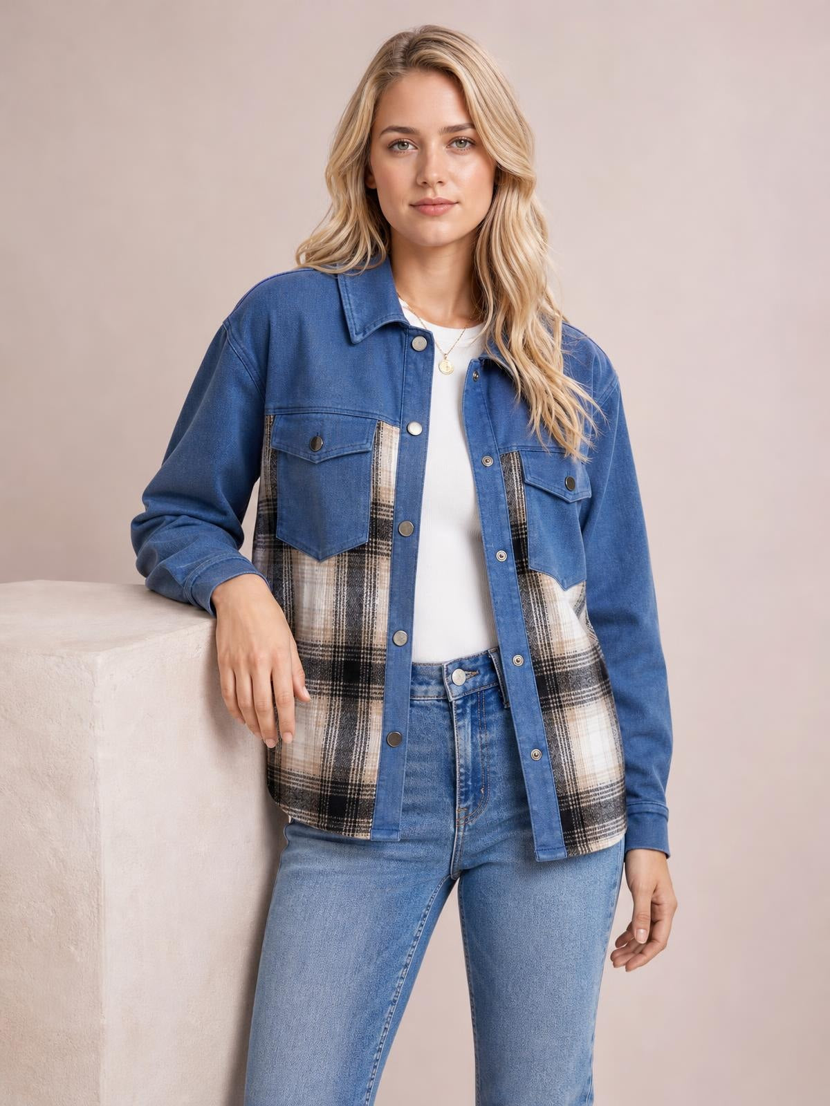 Model wearing a blue plaid button-up long-sleeve denim jacket with contrasting plaid front panels, flap pockets, collar, and a relaxed silhouette.