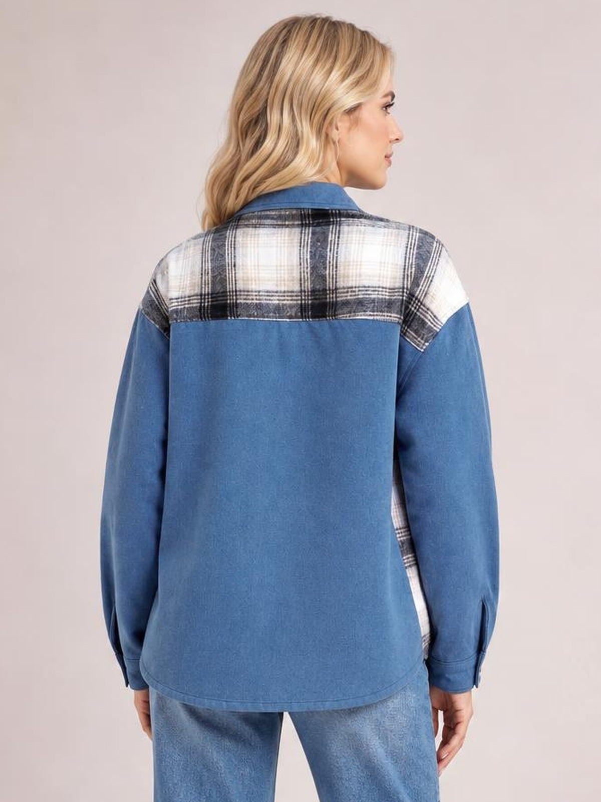 A model shows the back of a blue denim jacket with a black-and-white plaid yoke, long sleeves, button-up front, and relaxed straight silhouette.