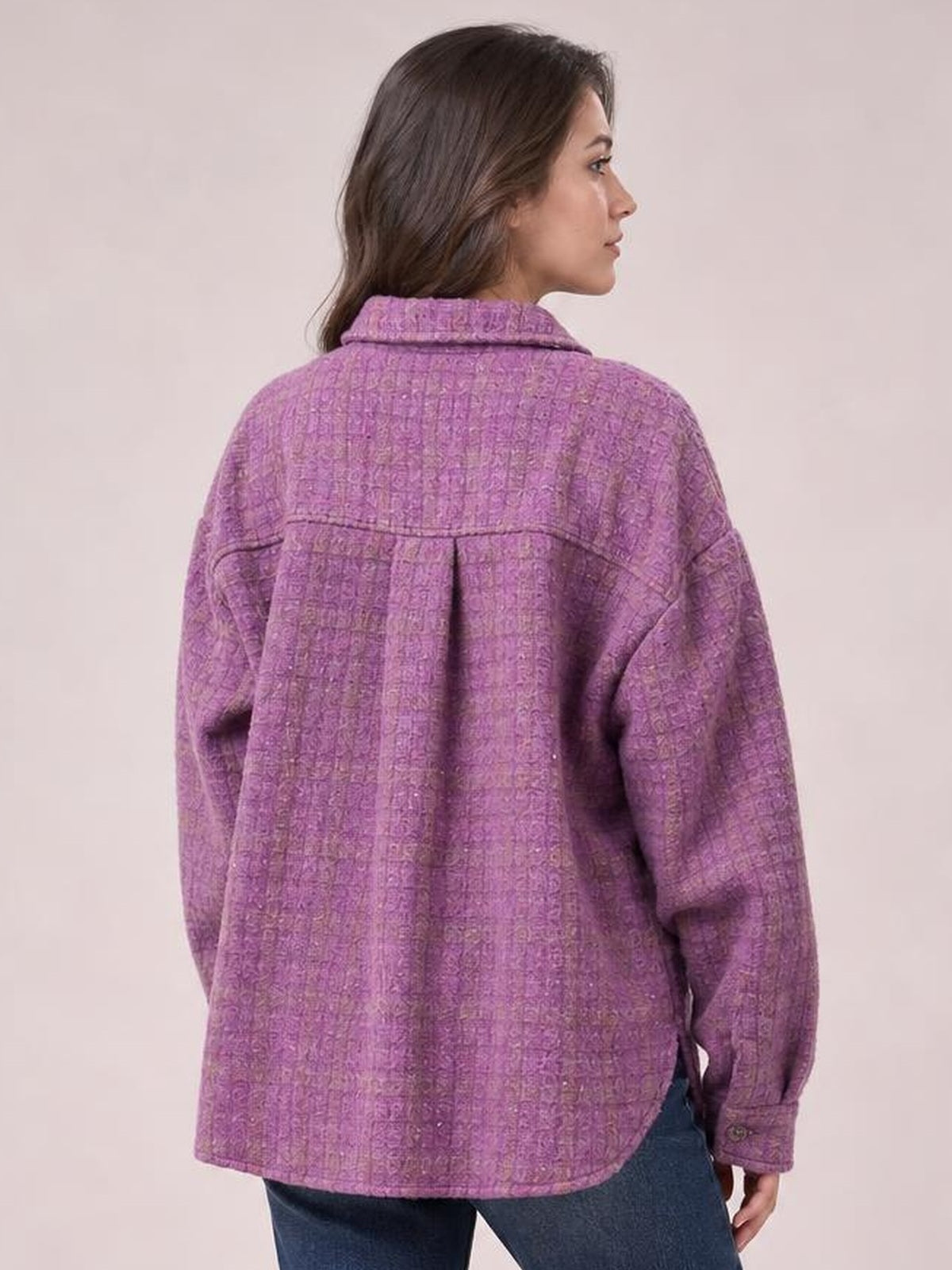 A model wears a purple plaid button-up jacket with long sleeves, a pointed collar, back yoke seam, relaxed oversized silhouette, and buttoned cuffs.